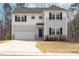 Charming two-story home with white siding, black shutters, and attached two car garage at 5439 Ripplebrook Rd, Durham, NC 27712