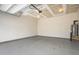 Unfinished garage with painted floors and an installed water heater at 5439 Ripplebrook Rd, Durham, NC 27712