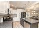 Bright kitchen features a large island with a sink, modern appliances, and white cabinets at 5439 Ripplebrook Rd, Durham, NC 27712
