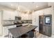 Modern kitchen with white cabinets, stainless steel appliances, and a gray granite island at 5439 Ripplebrook Rd, Durham, NC 27712