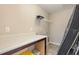 Functional laundry room with a countertop, storage, and a wire shelf for organized convenience at 5439 Ripplebrook Rd, Durham, NC 27712
