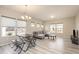 Open living area with modern gray floors, a large sofa, and a view into the kitchen at 5439 Ripplebrook Rd, Durham, NC 27712