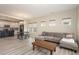 Spacious living room with ample natural light, wood floors, and an open kitchen in the background at 5439 Ripplebrook Rd, Durham, NC 27712