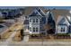 Aerial view of a gray two-story house with a landscaped yard and sidewalk at 5501 Advancing Ave, Raleigh, NC 27616