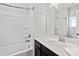 Bright bathroom with a bathtub shower combo and a single sink vanity at 5501 Advancing Ave, Raleigh, NC 27616