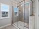 Modern bathroom features a glass-enclosed shower, neutral tile, and a bright window at 5501 Advancing Ave, Raleigh, NC 27616