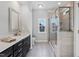 Modern bathroom with a walk-in shower, vanity with sink, and stylish finishes at 5501 Advancing Ave, Raleigh, NC 27616