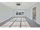 Bright bedroom with large windows, neutral carpet, and ensuite bath at 5501 Advancing Ave, Raleigh, NC 27616