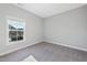 Empty bedroom features a light gray carpet, a large window, and neutral walls at 5501 Advancing Ave, Raleigh, NC 27616