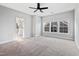 Inviting bedroom with ceiling fan, large windows, and neutral carpet at 5501 Advancing Ave, Raleigh, NC 27616