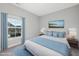 Stylishly staged bedroom with plush bedding, coordinated colors, and a picture window at 5501 Advancing Ave, Raleigh, NC 27616