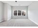Spacious bedroom with natural light from the large windows and neutral carpet at 5501 Advancing Ave, Raleigh, NC 27616