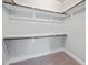 A large walk-in closet has shelving all around the top at 5501 Advancing Ave, Raleigh, NC 27616