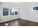 Bright dining room with hardwood floors and natural light from large windows at 5501 Advancing Ave, Raleigh, NC 27616