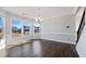 Light dining room with dark wood floors, and many windows for natural light and neighborhood views at 5501 Advancing Ave, Raleigh, NC 27616