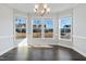 Bright dining room features a chandelier and large windows with neighborhood views at 5501 Advancing Ave, Raleigh, NC 27616