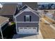 Gray home with a bright white garage door, tidy landscaping, and inviting curb appeal at 5501 Advancing Ave, Raleigh, NC 27616