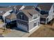 Charming gray home featuring a two-car garage, well-kept lawn, and neatly arranged landscaping at 5501 Advancing Ave, Raleigh, NC 27616