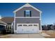 Front view of the two-car garage with gray siding and white trim at 5501 Advancing Ave, Raleigh, NC 27616