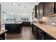 The spacious kitchen has granite countertops, stainless steel appliances and black cabinets at 5501 Advancing Ave, Raleigh, NC 27616