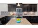 Kitchen island has granite countertops, stainless steel appliances, and dark cabinets at 5501 Advancing Ave, Raleigh, NC 27616