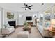 Staged living room featuring a fireplace, ceiling fan, and plenty of natural light at 5501 Advancing Ave, Raleigh, NC 27616