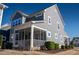 View of the screened porch, well-maintained landscaping and gray siding at 5501 Advancing Ave, Raleigh, NC 27616