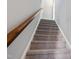 Carpeted staircase with wooden handrail leading to the upper level at 5501 Advancing Ave, Raleigh, NC 27616