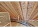 Unfinished attic space with wooden beams and exposed insulation, ready for customization at 6036 Epping Forest Dr, Raleigh, NC 27613