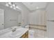 Well-lit bathroom featuring a vanity, mirror, and shower with a patterned curtain at 6036 Epping Forest Dr, Raleigh, NC 27613
