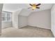 Neutral bedroom featuring carpeted floors, ceiling fan, a window and closet at 6036 Epping Forest Dr, Raleigh, NC 27613