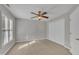 Spacious bedroom with a ceiling fan, window, and a large closet for ample storage at 6036 Epping Forest Dr, Raleigh, NC 27613