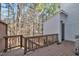 Private wooden deck with railing, offering a serene outdoor retreat surrounded by trees at 6036 Epping Forest Dr, Raleigh, NC 27613