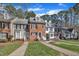 Charming townhomes with varied facades and well-manicured lawns create inviting curb appeal at 6036 Epping Forest Dr, Raleigh, NC 27613