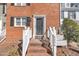 Inviting brick facade with a classic black door and white trim enhances the home's curb appeal at 6036 Epping Forest Dr, Raleigh, NC 27613