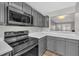 Bright kitchen with stainless steel microwave and electric stove at 6036 Epping Forest Dr, Raleigh, NC 27613