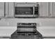 Close up of modern stainless steel appliances and white countertops at 6036 Epping Forest Dr, Raleigh, NC 27613