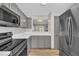 Cozy kitchen with stainless steel appliances, and a view to the living room at 6036 Epping Forest Dr, Raleigh, NC 27613