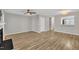 Spacious living room with ceiling fan, wood floors, and a partial view of the kitchen at 6036 Epping Forest Dr, Raleigh, NC 27613