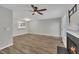 Cozy living room with a fireplace, wood floors, and access to the kitchen at 6036 Epping Forest Dr, Raleigh, NC 27613