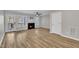 Open-concept living room with fireplace, access to the deck, and lovely wood floors at 6036 Epping Forest Dr, Raleigh, NC 27613