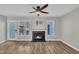 Open-concept living room featuring a fireplace, ceiling fan and wood flooring at 6036 Epping Forest Dr, Raleigh, NC 27613