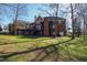 Lush backyard featuring a multi-tiered deck, mature trees offering shade, and an inviting green space at 6532 Wakefalls Dr, Wake Forest, NC 27587