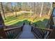 Backyard wooden steps provide access to lush lawn, enhancing the property's outdoor appeal at 6532 Wakefalls Dr, Wake Forest, NC 27587