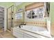 Bright bathroom with a soaking tub, a separate shower, and a large window with natural light at 6532 Wakefalls Dr, Wake Forest, NC 27587
