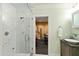 This bathroom features a glass enclosed shower, light green walls and a doorway to the home gym at 6532 Wakefalls Dr, Wake Forest, NC 27587