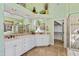 This bathroom features a double vanity and a walk in shower, as well as a large mirror and unique wallpaper at 6532 Wakefalls Dr, Wake Forest, NC 27587