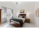 Cozy bedroom features a sloped ceiling, modern light fixture, and a painting above the wood-framed bed at 6532 Wakefalls Dr, Wake Forest, NC 27587