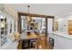 Sunlit breakfast nook with bench seating, wood table, and an open view to the kitchen and living room at 6532 Wakefalls Dr, Wake Forest, NC 27587