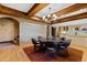 Elegant dining room with exposed wood beams, brick accent wall, and unique lighting at 6532 Wakefalls Dr, Wake Forest, NC 27587